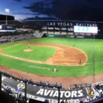 Las Vegas Ballpark at night with Aviators baseball game in progress, fans in stands, and scoreboard lit
