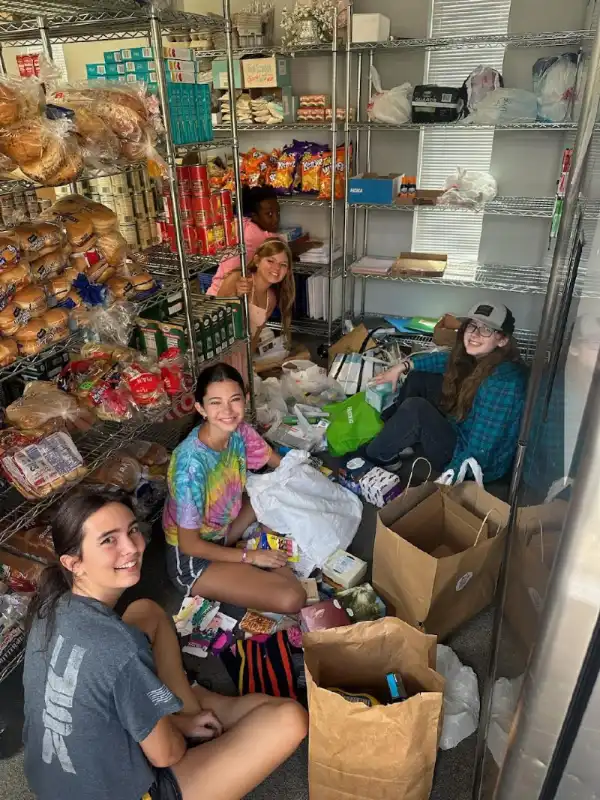 Youth volunteers preparing food donations at Desert Spring United Methodist Church pantry in Las Vegas, organizing supplies for families in need