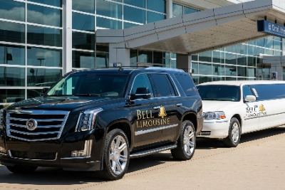 A variety of Bell Limousine's fleet in a professional shot, showing a Cadillac Escalade and a stretch limo with their professional logo, representing luxury services.