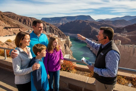 A family with two children poses for a photo during a scenic bus tour to the Hoover Dam