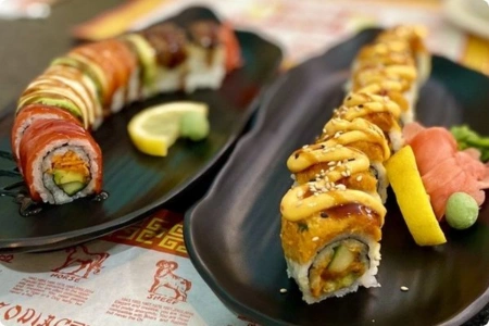 vegan sushi rolls with rainbow toppings creamy sauce and zodiac placemat at las vegas chinatown restaurant