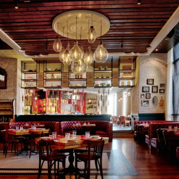 Buddy Rs Ristorante inside The Venetian Las Vegas with red leather booths wooden tables pendant lights and vintage decor