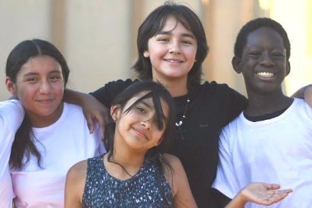 group of smiling children outdoors representing casa de luz youth programs and community outreach in las vegas
