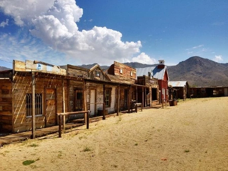 Chloride Ghost Town with wooden old west buildings red schoolhouse sandy ground and desert mountains