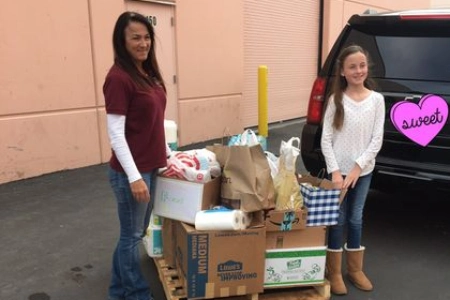 volunteers at helping hands of vegas valley in las vegas preparing senior food assistance supplies near pallet and suv