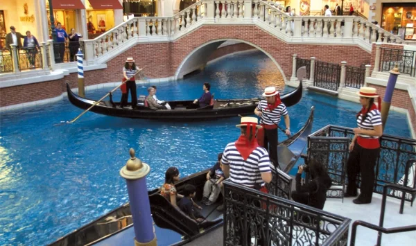 Indoor gondola ride at The Venetian Las Vegas with gondoliers ornate bridges Venetian architecture and painted sky ceiling