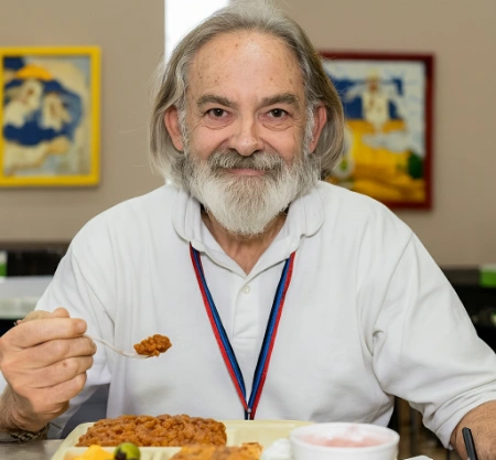An elderly man enjoying a Thanksgiving meal at the Las Vegas Rescue Mission