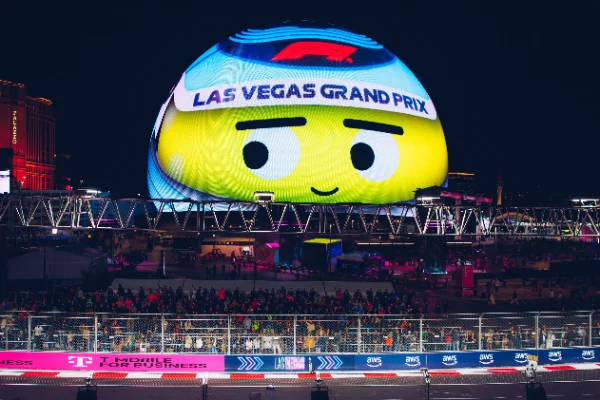 Formula One Grand Prix viewing zone near Las Vegas Sphere with animated helmet display crowd and illuminated race track