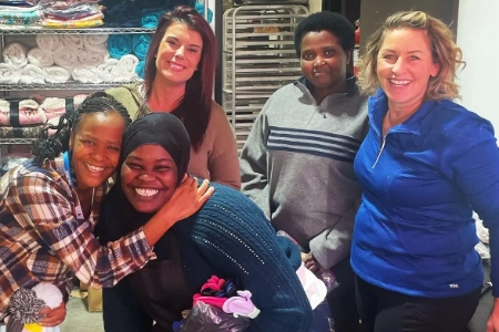 group of volunteers at lighthouse charities nutritional assistance facility organizing supplies and towels in north las vegas