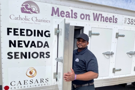 meals on wheels delivery truck operated by catholic charities las vegas with feeding nevada seniors signage and volunteer driver