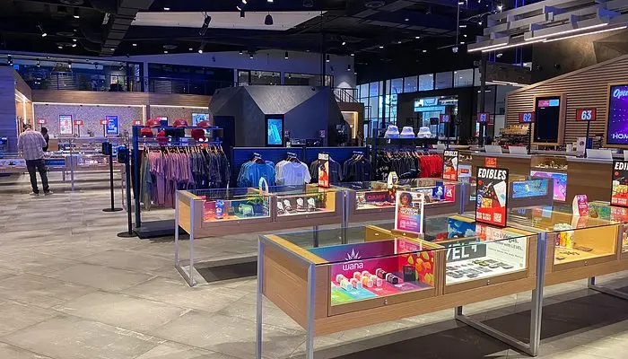 Interior of Planet 13 Las Vegas dispensary with sleek displays, cannabis products, and clothing racks