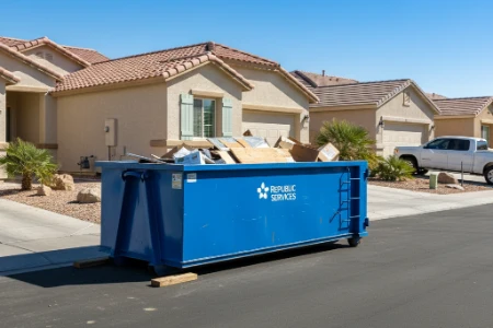 A residential roll off dumpster parked in a driveway ready for junk removal in Las Vegas