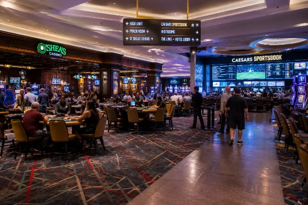 Adult guests explore the contemporary casino floor, O’Sheas gaming area, and Caesars Sportsbook inside The LINQ Hotel + Experience.