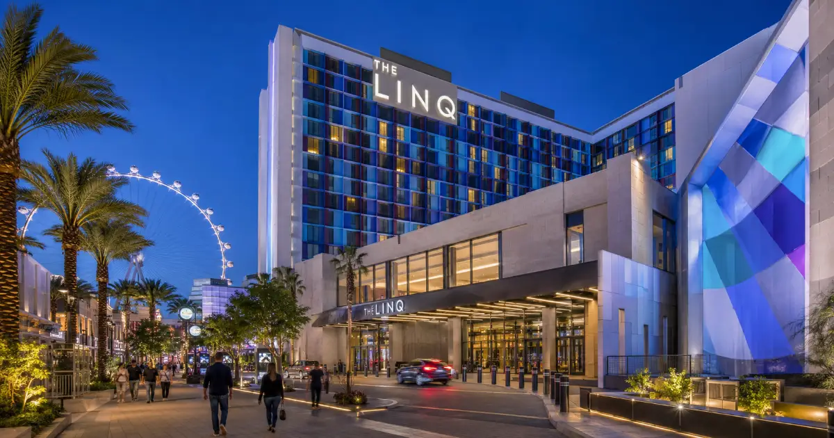 The LINQ Hotel + Experience features its modern hotel tower, permanent signage, promenade entrance, and the nearby High Roller on the Las Vegas Strip.