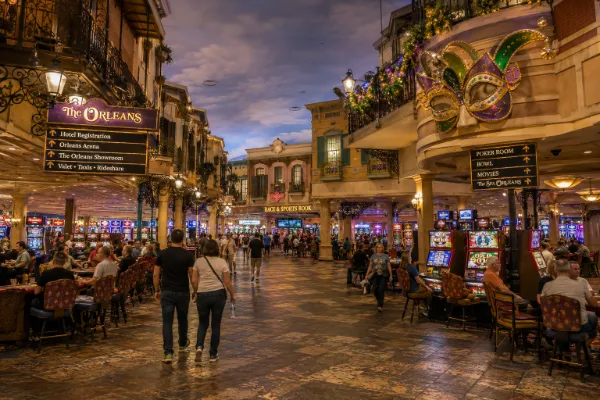 Mardi Gras-inspired masks, decorative balconies, gaming areas, and broad walkways fill the interior of The Orleans Hotel & Casino.