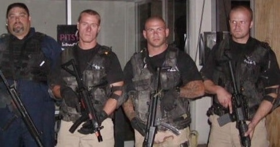 Four individuals in tactical gear with rifles posing indoors during Vegas Tactical Adventures training session in Las Vegas