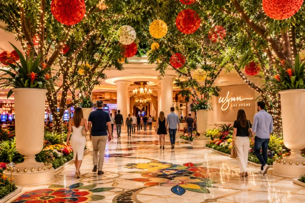 Floral details, indoor greenery, decorative lighting, and broad walkways define the public interior of Wynn Las Vegas.