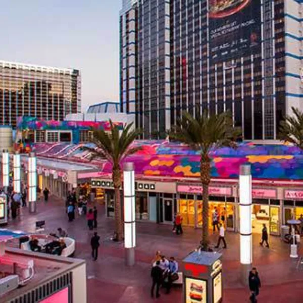 A view from the front of the Grand Bazaar shops at the horseshoe Las Vegas numerous shops and restaurants glowing at dusk on the strip