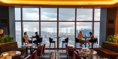 The elegant interior of Alle Lounge on 66 at Resorts World with panoramic views of Las Vegas through the floor to ceiling windows