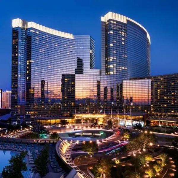 illuminated aria resort and casino in las vegas with modern glass towers and central fountain