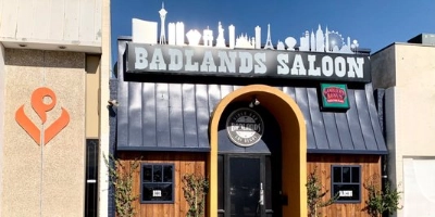 exterior of badlands saloon las vegas oldest gay bar with black signage and western-style entrance in commercial center