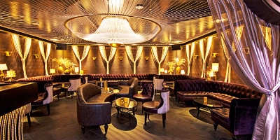 upscale speakeasy-style lounge at beauty and essex in las vegas cosmopolitan with velvet seating chandeliers and ambient lighting