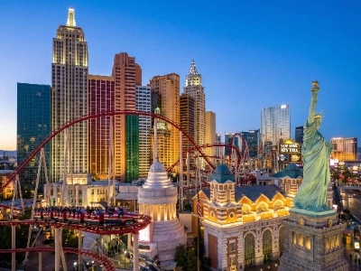 The Big Apple Coaster with a loop twisting around the New York-New York Hotel facade.