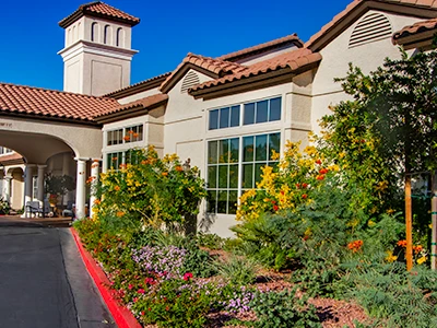 HOA building with desert landscaping, native plants, and palm trees in Las Vegas neighborhood