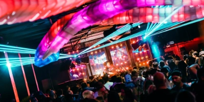 The signature octopus-shaped light installation pulsing with red light over the dance floor at Discopussy on Fremont Street
