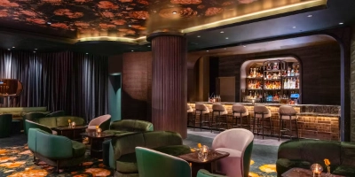 hidden speakeasy bar easys in aria las vegas with velvet seating live jazz and vintage decor behind donut shop