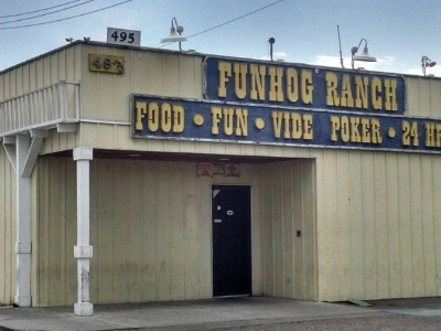 exterior of fun hog ranch gay bar in las vegas with 24-hour signage and video poker tavern entrance