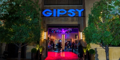 entrance and interior of gipsy nightclub gay bar in las vegas with illuminated signage vibrant lighting and modern lounge decor
