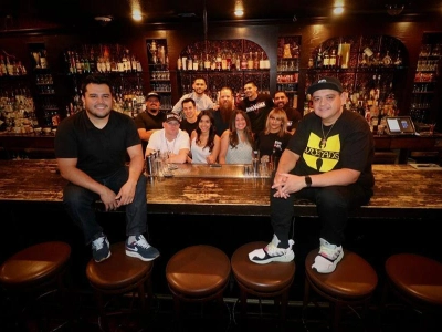 group enjoying steaks and cocktails at herbs and rye