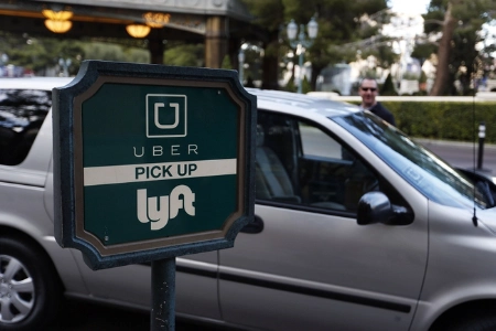 designated ride share pickup zone at las vegas resort with uber lyft signage and parked vehicle illustrating modern transportation access
