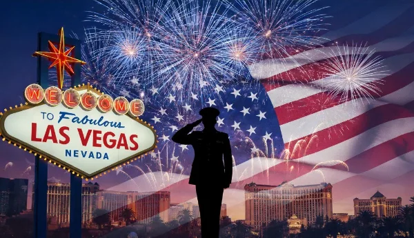 american flag fireworks and saluting soldier over las vegas strip with welcome sign and hotel skyline