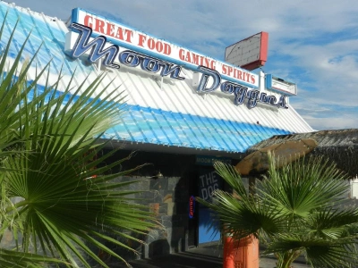 exterior of moon doggies dive bar in las vegas with signage for food gaming and spirits