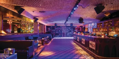 entrance and vibrant bar inside On The Record nightclub at Park MGM Las Vegas