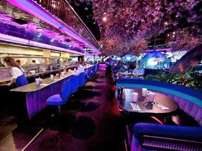 interior of peppermill restaurant las vegas with neon lighting and cozy booths