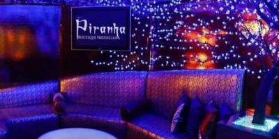 interior of piranha nightclub gay bar in las vegas with boutique lounge seating illuminated decor and vibrant nightlife ambiance
