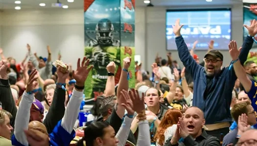excited football fans cheering indoors at plaza hotel big game super bowl party in downtown las vegas with large screen and festive atmosphere