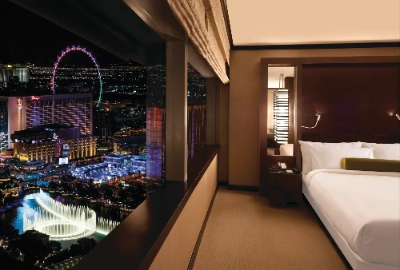 romantic las vegas hotel suite with nighttime view of bellagio fountains high roller and strip lights