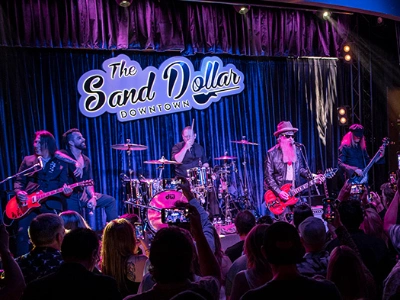live music at sand dollar downtown dive bar in las vegas with stage lighting and band performance
