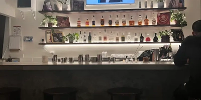 interior of seven45 speakeasy bar in las vegas with warm lighting modern liquor shelves and cozy cocktail counter illustrating upscale arts district nightlife