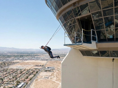 Man jumping off the 108th floor of The STRAT tower in a controlled freefall harness.