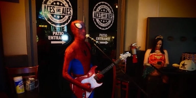 Costumed performer playing guitar and singing karaoke at Aces And Ales bar in Las Vegas