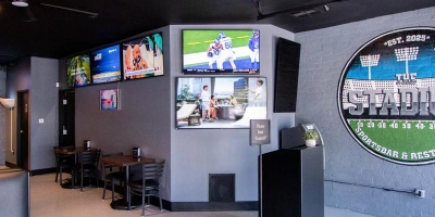 televisions with sports games playing surround the entrance to the stadium sports bar in the downtown Las Vegas arts district