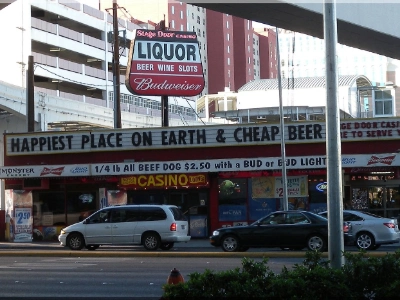 exterior of stage door casino dive bar in las vegas with signage for video poker cheap beer and liquor