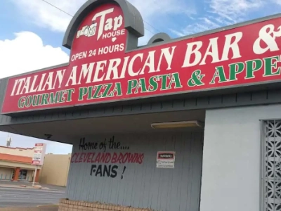 exterior of tap house italian american dive bar in las vegas with signage for pizza and video poker