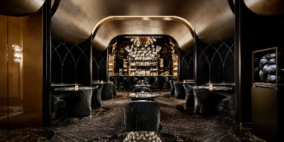 luxurious speakeasy lounge the vault at bellagio las vegas with black marble decor plush seating and illuminated bar showcasing rare spirits