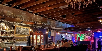 eclectic downtown las vegas speakeasy interior at velveteen rabbit with chalkboard beer menu and vintage decor